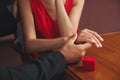 Man with engagement ring making proposal to his girlfriend at table, closeup Royalty Free Stock Photo