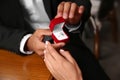 Man with engagement ring making proposal to his girlfriend at table, closeup Royalty Free Stock Photo