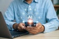 Man engages AI applications with his smartphone, creating a technologically advanced and interconnected system Royalty Free Stock Photo