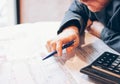 Man engineer designer architect reading drawings at table