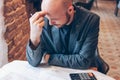 Man engineer designer architect reading drawings at table in cafe Royalty Free Stock Photo