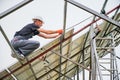 Male workers mounting solar panel system outdoors.