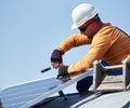 Electrician mounting solar panel on roof of modern house Royalty Free Stock Photo