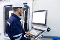 Man engineer using computer blank white screen controlling cnc machine at workshop. Male control automated machine process