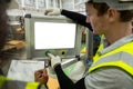Man engineer using computer blank white screen controlling machine at workshop. Male control automated machine process programming Royalty Free Stock Photo