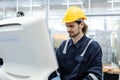 Man engineer using computer controlling cnc machine at workshop. professional male control automated machine process programming Royalty Free Stock Photo