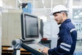 Man engineer using computer controlling cnc machine at workshop. professional male control automated machine process programming Royalty Free Stock Photo