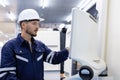 Man engineer using computer controlling cnc machine at workshop. professional male control automated machine process programming Royalty Free Stock Photo