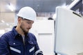 Man engineer using computer controlling cnc machine at workshop. professional male control automated machine process programming Royalty Free Stock Photo