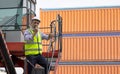 Man engineer using walkie-talkie in shipping yard, Industrial worker is controlling container loading by walkie talkie in import-