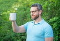 man enjoy and cheers with coffee outdoor. photo of man enjoy coffee. man enjoy coffee.