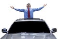 Man enjoy freedom on the sunroof of car