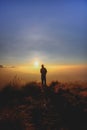 Man enjoying beautiful cloudscape sunrise on top of mountain cliff Royalty Free Stock Photo