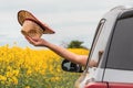 Man enjoying car ride in summer countryside landscape, hand with straw hat reaching out the window Royalty Free Stock Photo