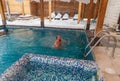 Man enjoying a leisurely swim in a snowcovered swimming pool Royalty Free Stock Photo