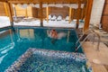 Man enjoying a leisurely swim in a snowcovered swimming pool Royalty Free Stock Photo