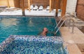 Man enjoying a leisurely swim in a snowcovered swimming pool Royalty Free Stock Photo