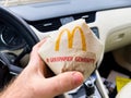 Man Enjoying a McDonalds Burger in His Car