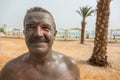 Man enjoying mud from Dead Sea, Israel Royalty Free Stock Photo