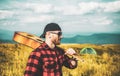 Man enjoying nature. Handsome traveler with guitar in autumn mountain. Royalty Free Stock Photo