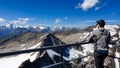 Man enjoying the panoramic view from Hoher Sonnblick on mountain ranges of High Tauern Alps in Carinthia, Salzburg, Austria,