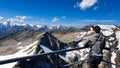 Man enjoying the panoramic view from Hoher Sonnblick on mountain ranges of High Tauern Alps in Carinthia, Salzburg, Austria,