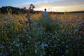 Man enjoying Spring sunset on field. The Urals landscape