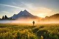 man enjoying a sunrise hike through the misty meadow, with mountain peaks in the background