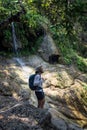 Man enjoying the waterfall and the jungle in Thailand Royalty Free Stock Photo