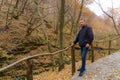 Man enjoys a walk in the autumn forest. Background with copy space for text . The concept of solitude with nature