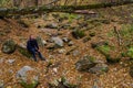 Man enjoys wildlife with stones in the autumn forest. Background with copy space. The concept of solitude with nature