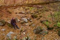 Man enjoys wildlife with stones in the autumn forest. Background with copy space. The concept of solitude with nature