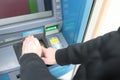 Man entering pin code at ATM and covering it with his hand closeup Royalty Free Stock Photo