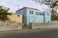 A man enters a highly decorated Light Blue Portuguese style House in Sao Tome.