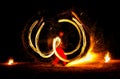 Man entertains with the help of fire, carrying fire performance night. Royalty Free Stock Photo