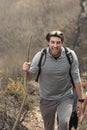 Young man enjoying the nature. Bearded man smiling. Hiker in the middle of a journey