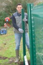 Man erecting garden fence