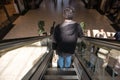 Man on escalator in shopping mall centre Royalty Free Stock Photo