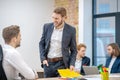 Man with evil grimace standing near employee