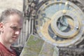 Man examines the map on background of historical medieval astronomical Clock on the Old Royalty Free Stock Photo