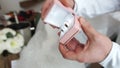 A man examines and shows wedding rings in a box with lighting.