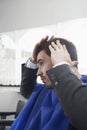 Man Examining Freshly Cut Hair Royalty Free Stock Photo