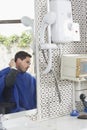 Man Examining Freshly Cut Hair Royalty Free Stock Photo