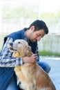 Man examining golden retriever dog Royalty Free Stock Photo