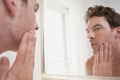 Man Examining His Stubble In Mirror Royalty Free Stock Photo