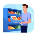 Man examining refrigerator filled fresh vegetables fruits. Young adult male choosing healthy food