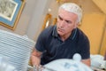 Man examining stack crockery Royalty Free Stock Photo