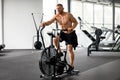 Man exercise bike gym cycling training fitness. Fitness male using air bike cardio workout Royalty Free Stock Photo