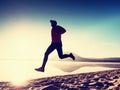 Man exercising on beach. Silhouette of active man exercising and stretching at lake Royalty Free Stock Photo