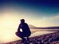 Man exercising on beach. Silhouette of active man exercising and stretching at lake Royalty Free Stock Photo